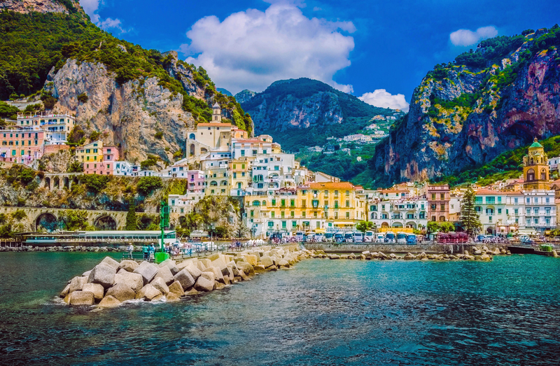  The small haven of Amalfi village with a turquoise sea and colorful houses on the slopes of the coast, Salerno, Italy