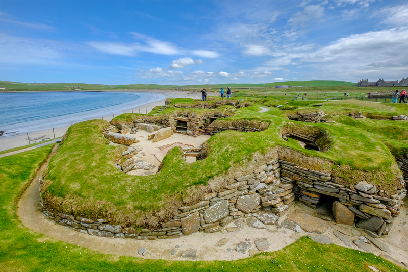 Tourists visiting Skara Brae, a Neolithic settlement located in the Mainland Orkney, Scotland