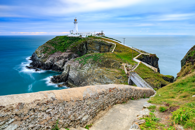 Lighthouse on coastal island with horizon at South Stack in Holyhead, North Wales