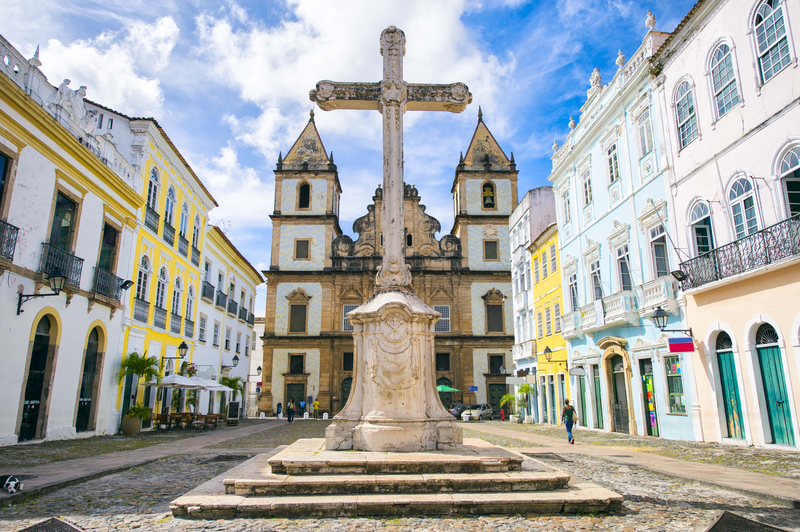 Bright view of Pelourinho in Salvador, Brazil, dominated by the large colonial church Cruzeiro de Sao Francisco Christian stone cross in the Praça Anchieta