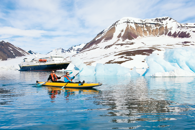 A family explores by Kayak in Spitsbergen, Svalbard Archipelago from the ship National Geographic Explorer