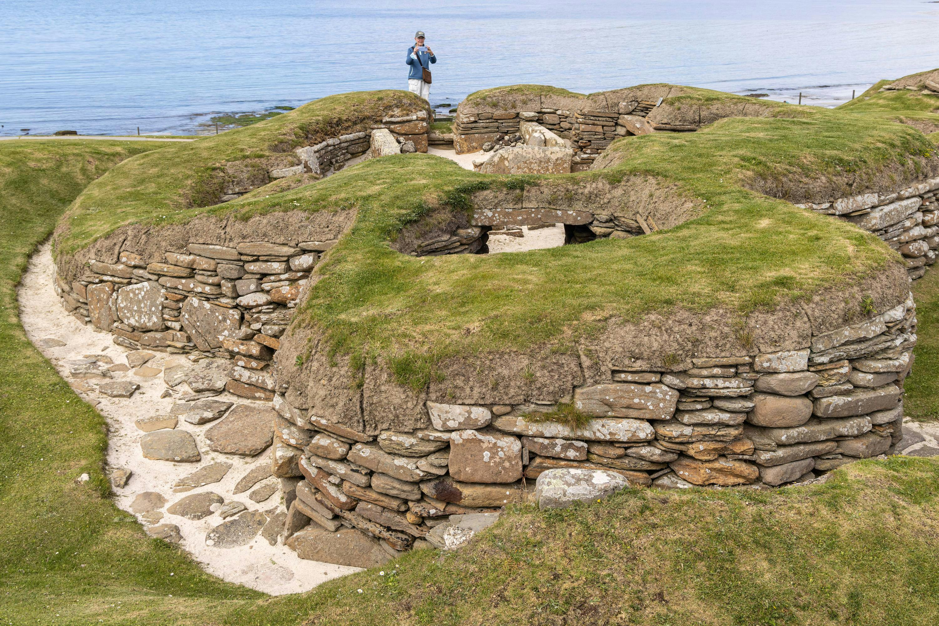 Guests visiting Skara Brae, a Neolithic settlement located in the Mainland Orkney Islands, Scotland