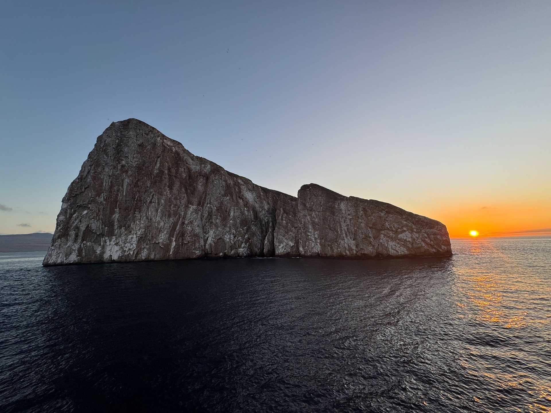 a rocky island at sunset