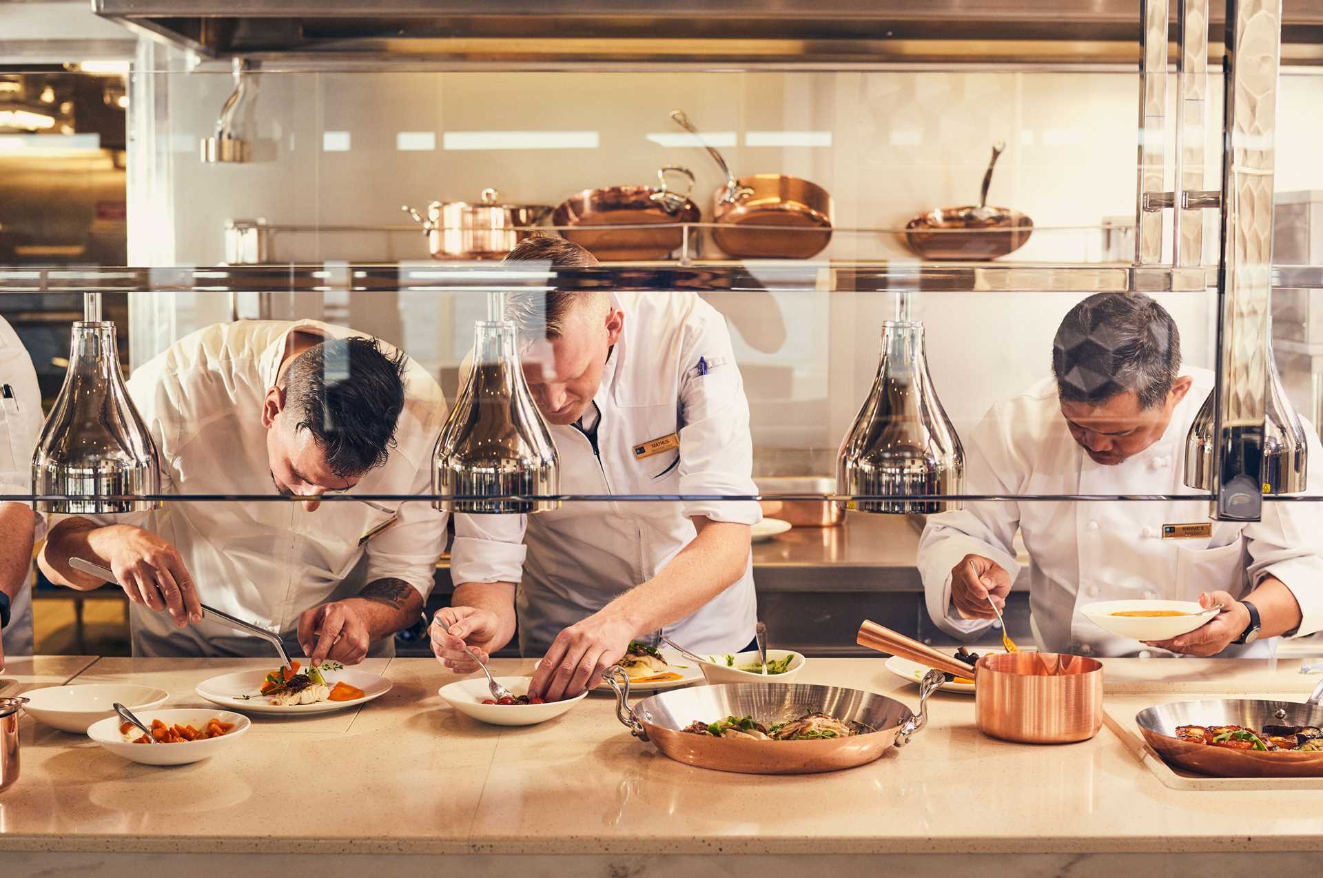 Chefs prepare food in the kitchen aboard National Geographic Endurance