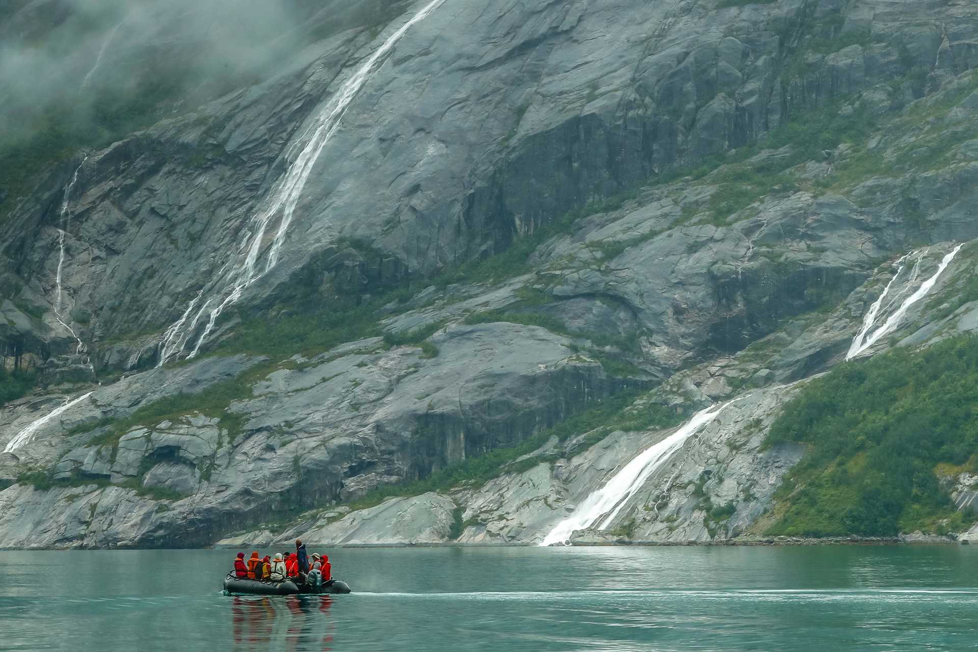 Guests travel by Zodiac in Nordfjord in Svalbard, Norway