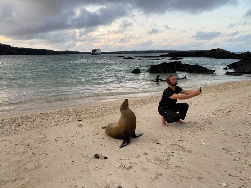 man taking selfie with sea lion