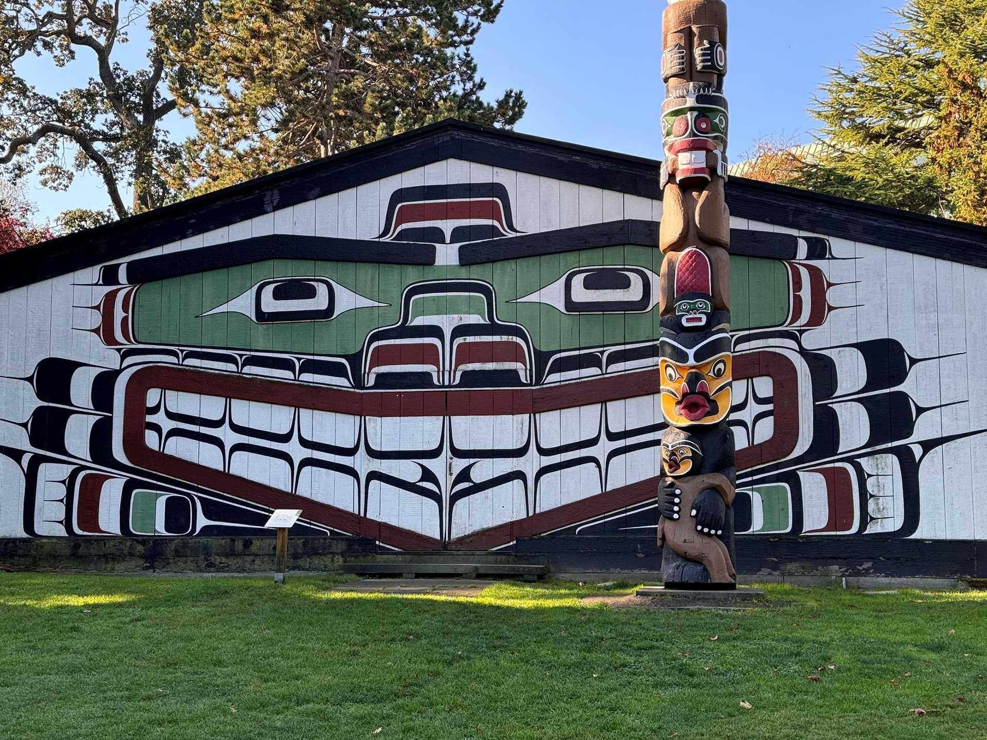 totem pole and big house with traditional designs