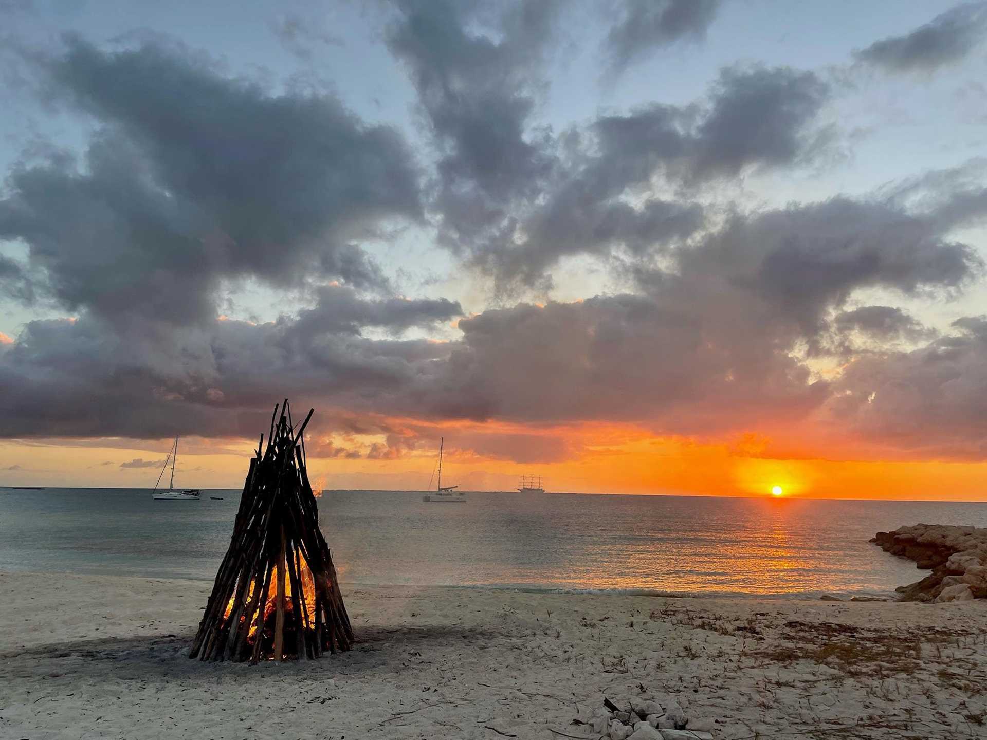 bonfire on beach at sunset